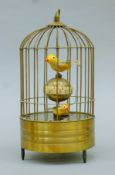 A birdcage clock. 21 cm high.
