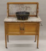 An Edwardian mahogany marble-topped wash stand with toleware basin (drilled for plumbing).