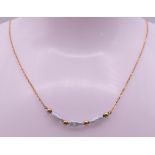 A 9 ct gold and pearl necklace. Approximately 40 cm long. 1.7 grammes total weight.