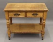 A Victorian oak two-drawer side table. 91 cm wide.