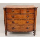 A Georgian mahogany bow-front two-over-three chest of drawers. 124 cm wide x 114 cm high.