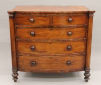 A Georgian mahogany bow-front two-over-three chest of drawers. 124 cm wide x 114 cm high.