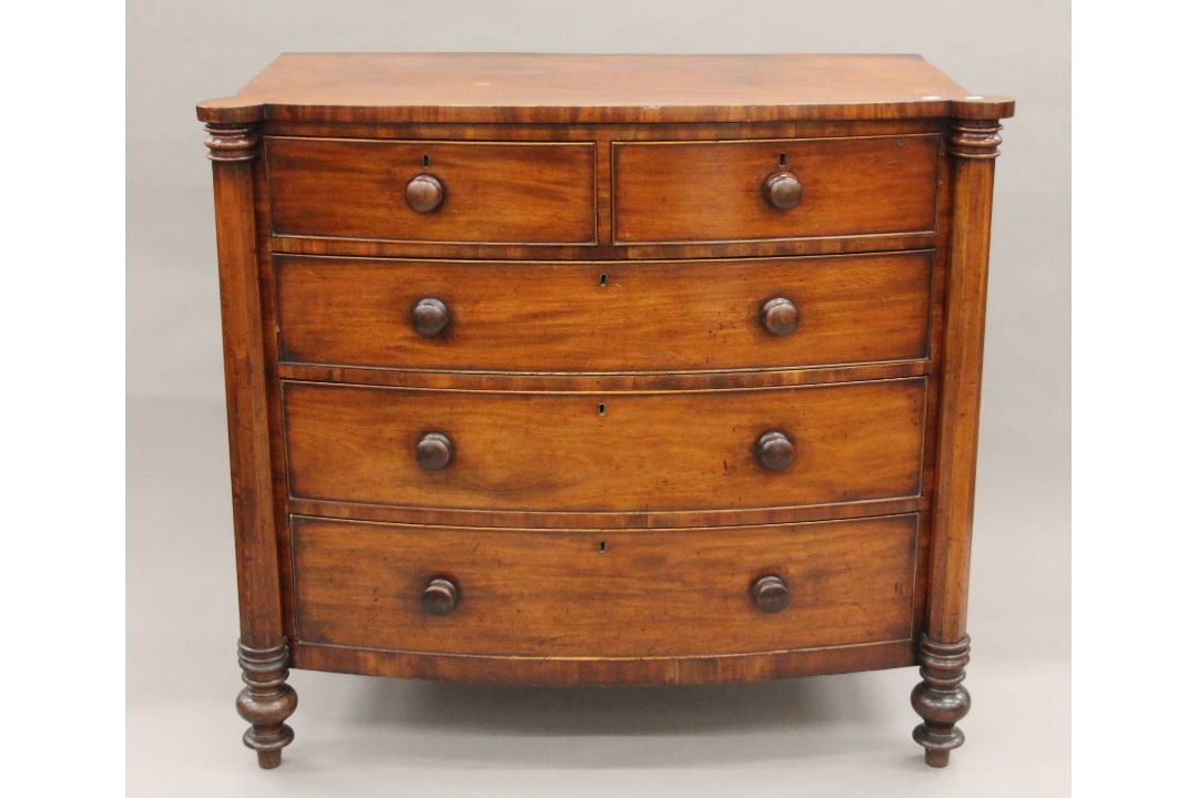 A Georgian mahogany bow-front two-over-three chest of drawers. 124 cm wide x 114 cm high. - Image 1 of 7