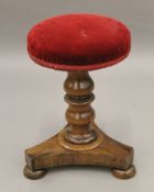 A Victorian rosewood piano stool. 29 cm diameter.