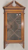 An Edwardian mahogany hanging corner cabinet. 109 cm high.