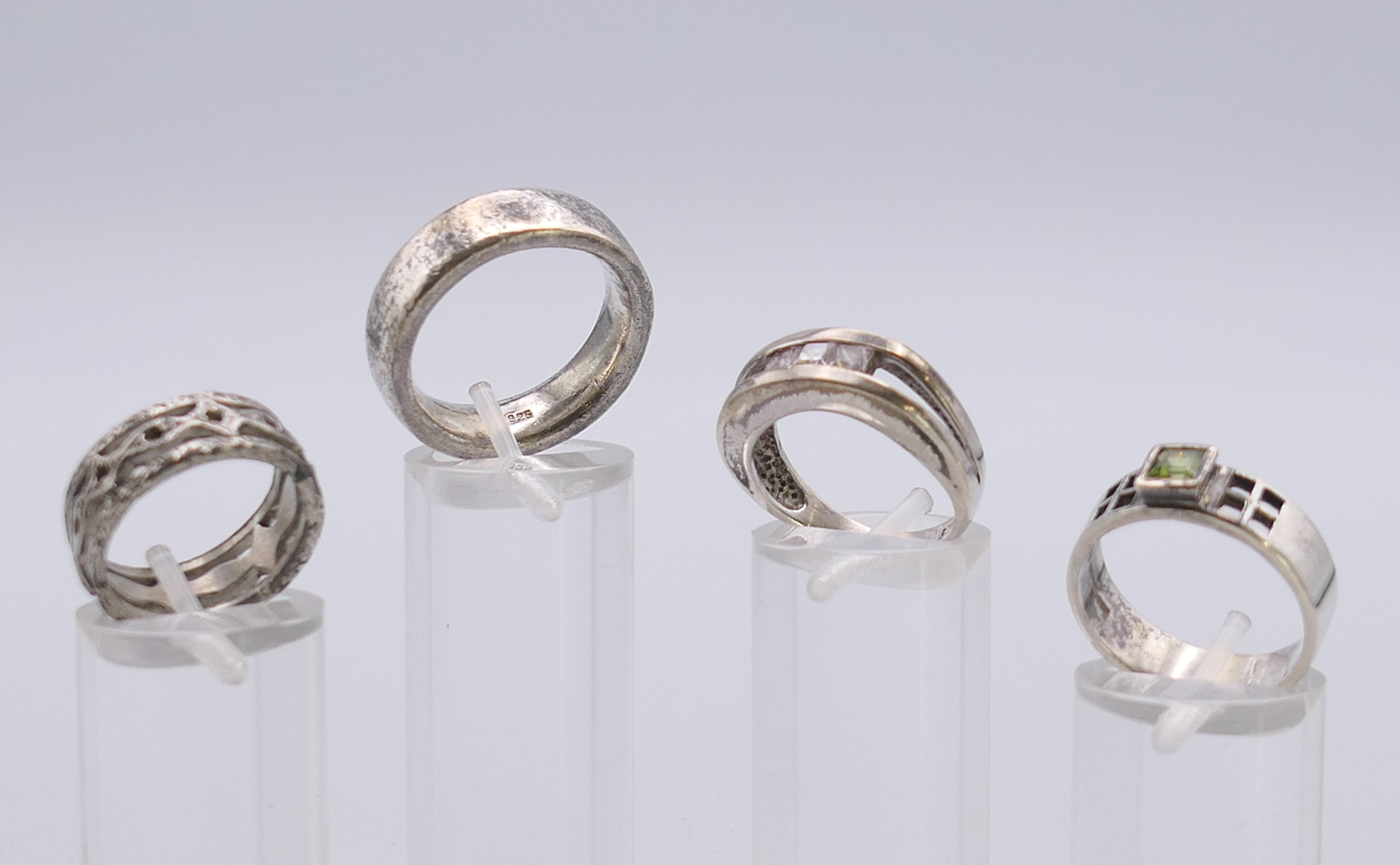 Four silver rings. Green stone ring size P.