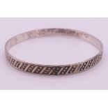 A silver bangle. 0.6 cm high.
