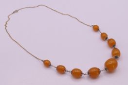An amber graduated bead necklace with Russian marks. 60 cm long.