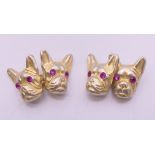 A pair silver cufflinks in the form of dog's heads bearing Russian marks. 1.5 cm high.
