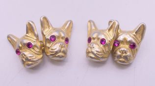A pair silver cufflinks in the form of dog's heads bearing Russian marks. 1.5 cm high.