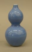 A Chinese porcelain blue double gourd vase. 11 cm high.