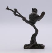 A bronze bird perched on a tree branch. 9 cm high.
