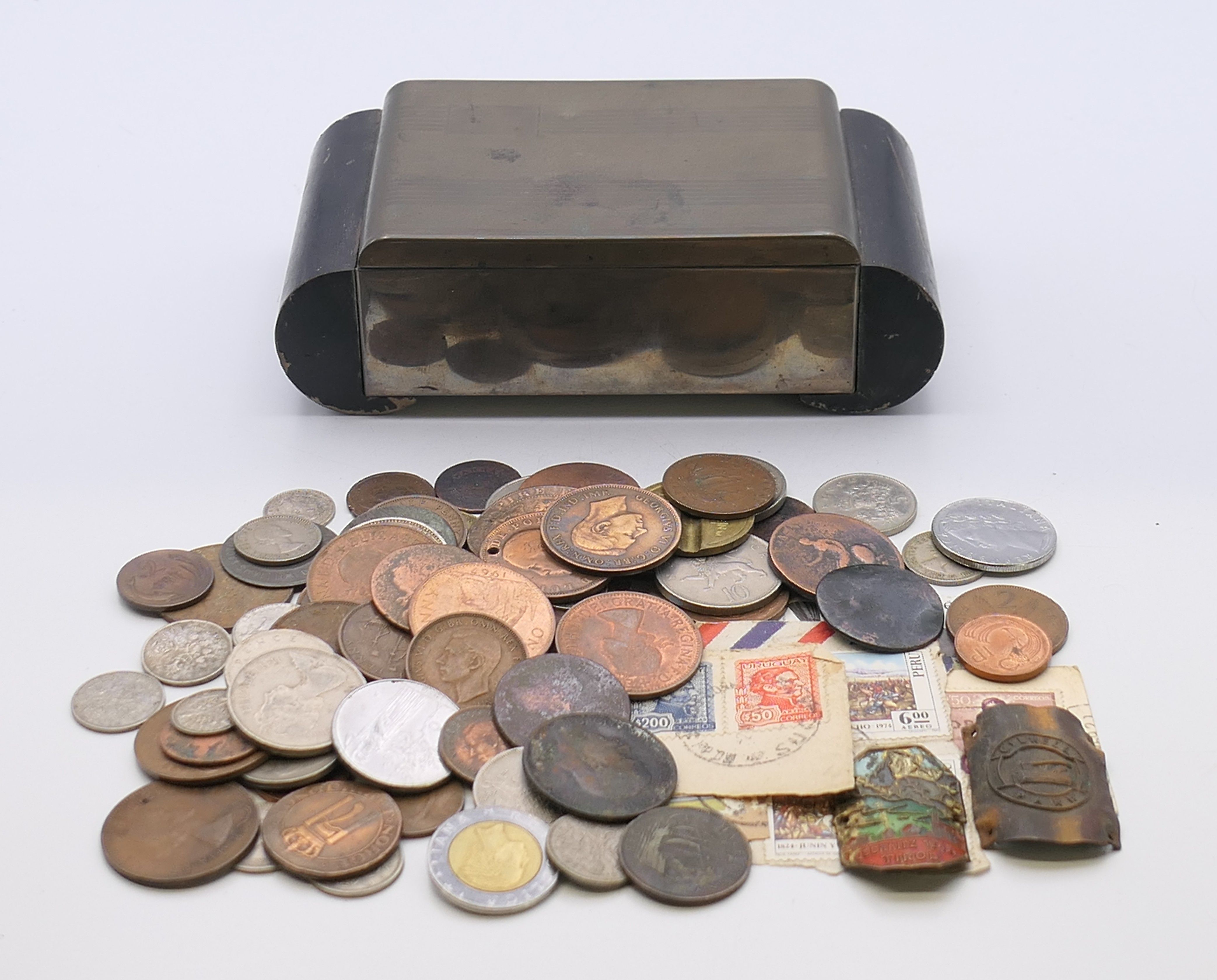 An Art Deco metal and wood cigarette box containing a quantity of coins. Box 15.5 x 8.25 x 4.5 cm.