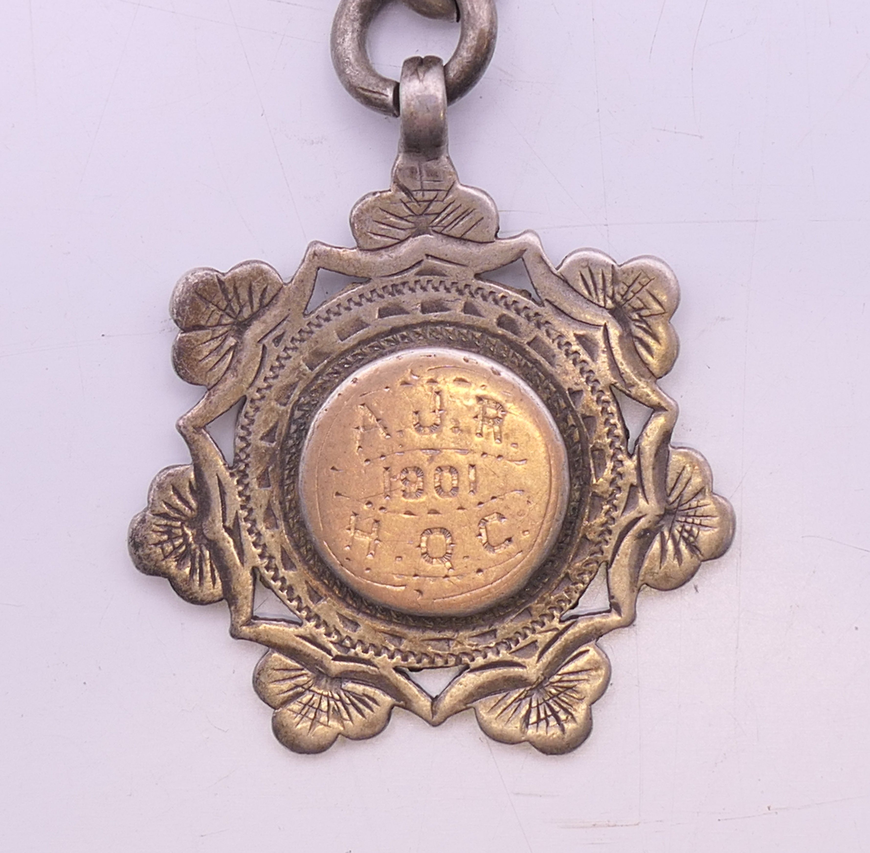 A silver Albert pocket watch chain and fob, the fob engraved AJR 1901 HQC. 38 cm long, fob 3.