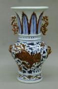A Chinese porcelain blue and red vase decorated with dragons. 36 cm high.