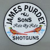 A cast iron 'Purdey & Sons' sign. 23.5 cm diameter.
