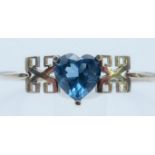 A silver bangle with heart shaped blue stone. Heart 1.5 cm high.