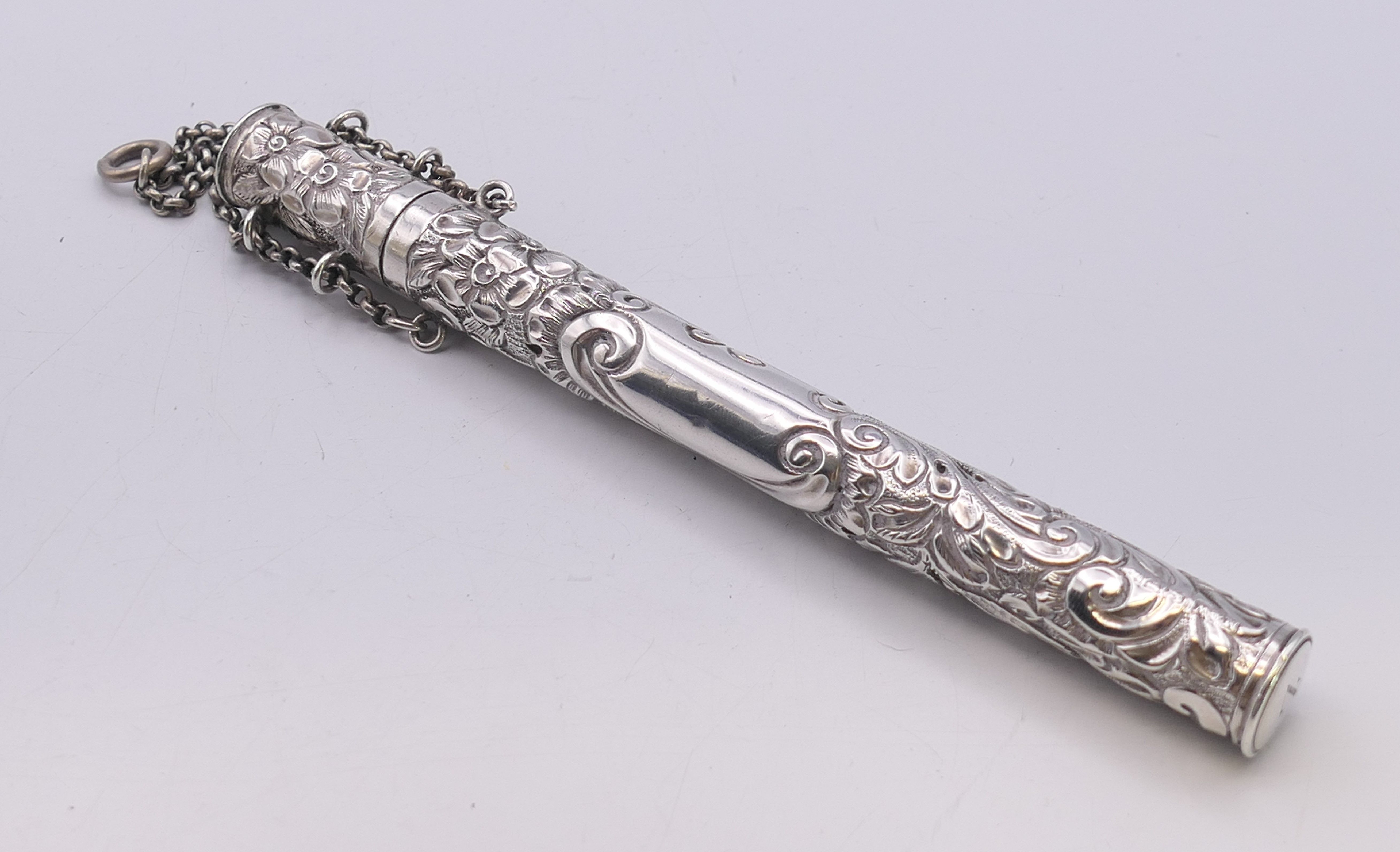 An embossed silver needle case. 14 cm high.