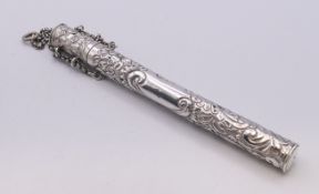 An embossed silver needle case. 14 cm high.