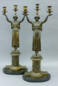 A pair of bronze Empire-style candelabra on plinth bases. 74 cm high.