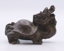 A small bronze dragon. 4 cm high.