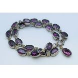 A vintage two strand alternating purple and clear stone bracelet. 19 cm long.