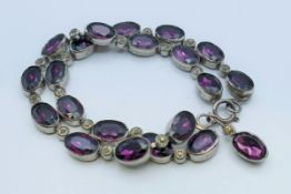 A vintage two strand alternating purple and clear stone bracelet. 19 cm long.