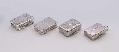 Four Victorian silver vinaigrettes. Larger 2.5 x 1.75 cm.