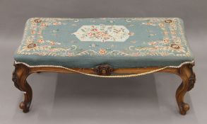 A Victorian mahogany tapestry-topped stool. 93 cm long x 36 cm high.