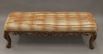 A Victorian walnut stool. 115 cm long x 37 cm high.