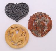 Three Chinese stone roundels/pendants. Heart roundel 5.5 cm high.