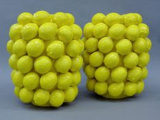 A pair of porcelain vases decorated with lemons. Each 30 cm high.