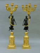 A pair of gilt bronze figural candelabra. 71 cm high.
