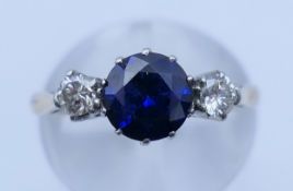 An 18 ct gold sapphire and diamond ring. Ring size L/M.