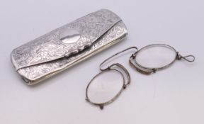 A pair of antique steel framed spectacles in a silver case. Case 11 cm x 4.5 cm.