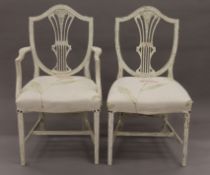 Two cream-painted shield back chairs, one with arms. The latter 56 cm wide.