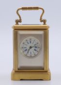 A miniature carriage clock. 5.5 cm high excluding handle.