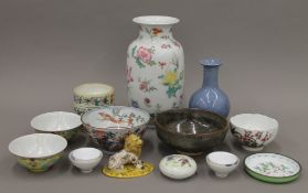 A quantity of Chinese porcelain and enamel items and a faience lion. The largest vase 24.5 cm high.