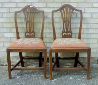 A pair of 19th century Hepplewhite-style mahogany dining chairs with drop in seats. 51 cm wide.