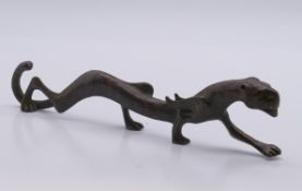 A bronze tiger scroll weight. 18 cm long.