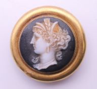 A 19th century unmarked cameo brooch. 2.5 cm diameter. 7 grammes total weight.