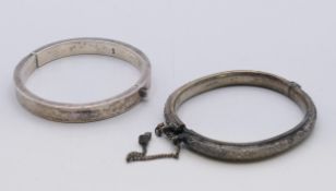 Two silver bracelets/bangles. Plain bangle 0.5 cm wide, 0.75 cm high, 6 cm internal diameter.