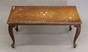 An Eastern brass-inlaid coffee table. 91 cm long x 41.5 cm high.