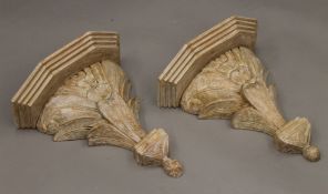 A pair of carved wooden wall brackets. Each 37.5 cm wide x 42.5 cm high.