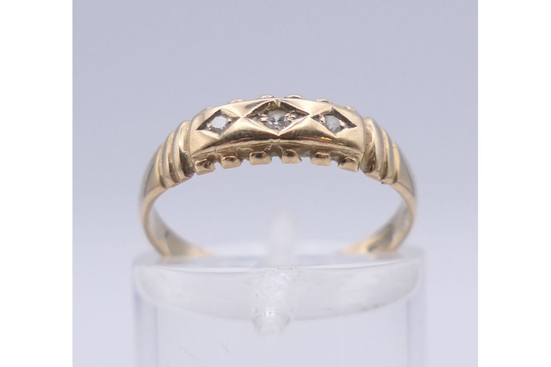A 9 ct gold three stone diamond ring. Ring size L. 1.3 grammes total weight. - Image 3 of 7