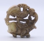 A jade roundel of an elephant and peacock. 5.25 cm diameter.