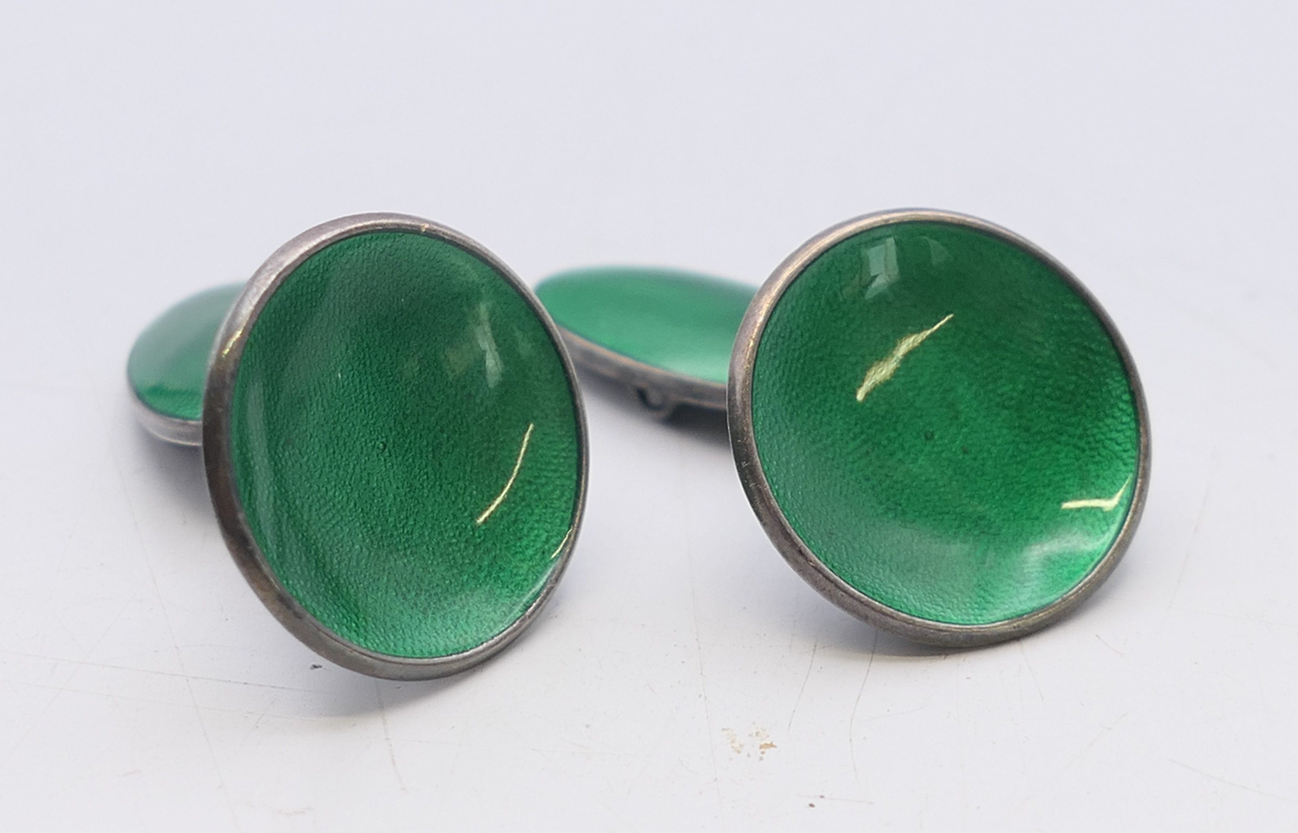 A pair of Norwegian silver and green enamel cufflinks. 1.75 cm diameter.