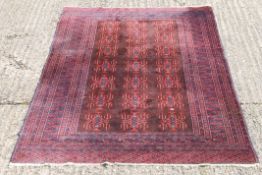 A Persian red ground rug. 120 x 180 cm.