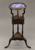 A George III mahogany tripod washstand set with a Copeland Spode's Italian bowl. 84 cm high.