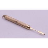 A 9 ct gold hallmarked retractable toothpick. 5.7 grammes. 5 cm closed, 7.5 cm open.
